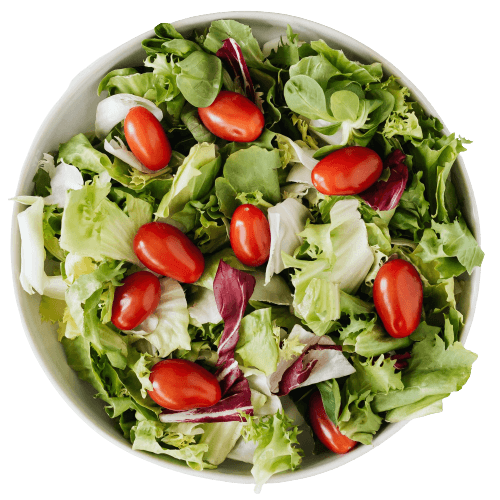 Cherry tomatoes, romaine lettuce and french lettuce  salad in a round white bold.